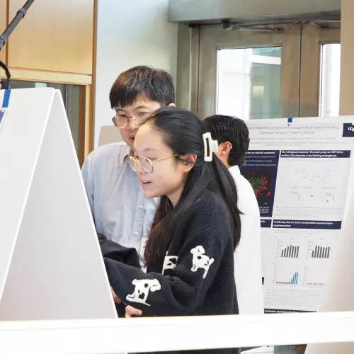 Two scholars discussing poster